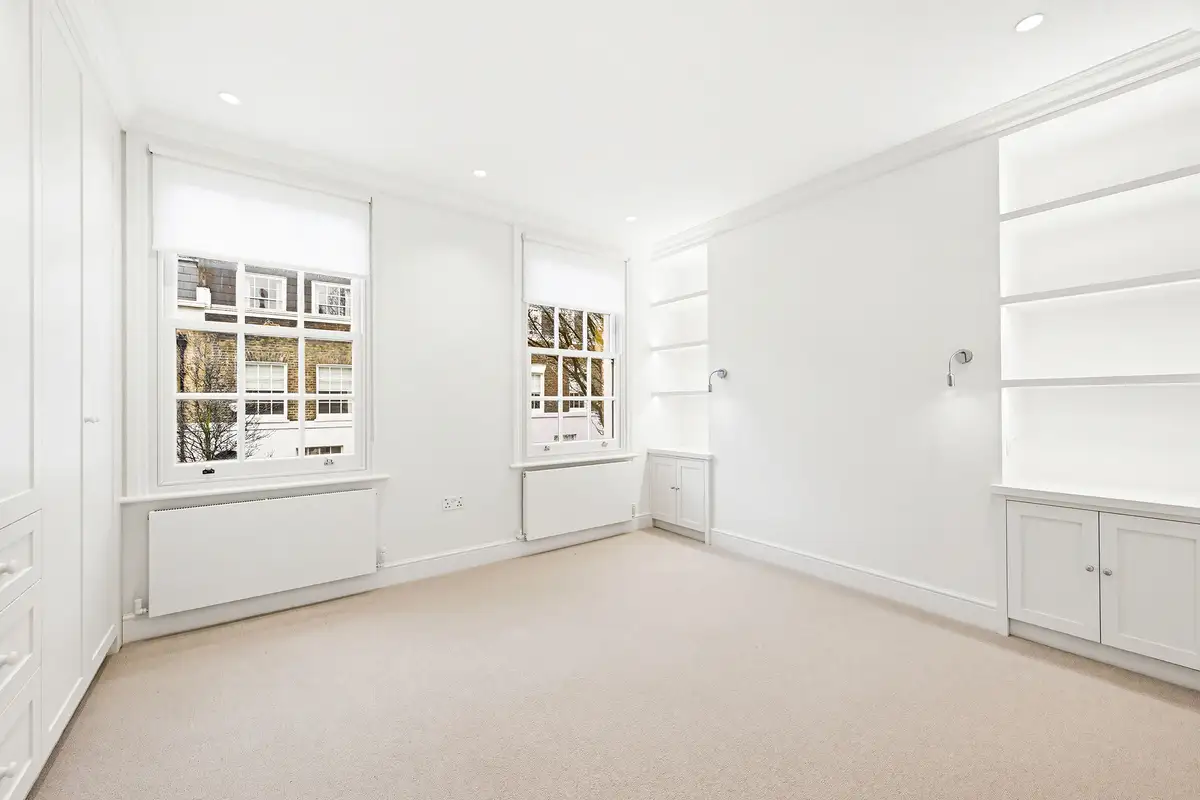The same bedroom after CGI dressing, with upholstered bed and reading chair, Markham Street